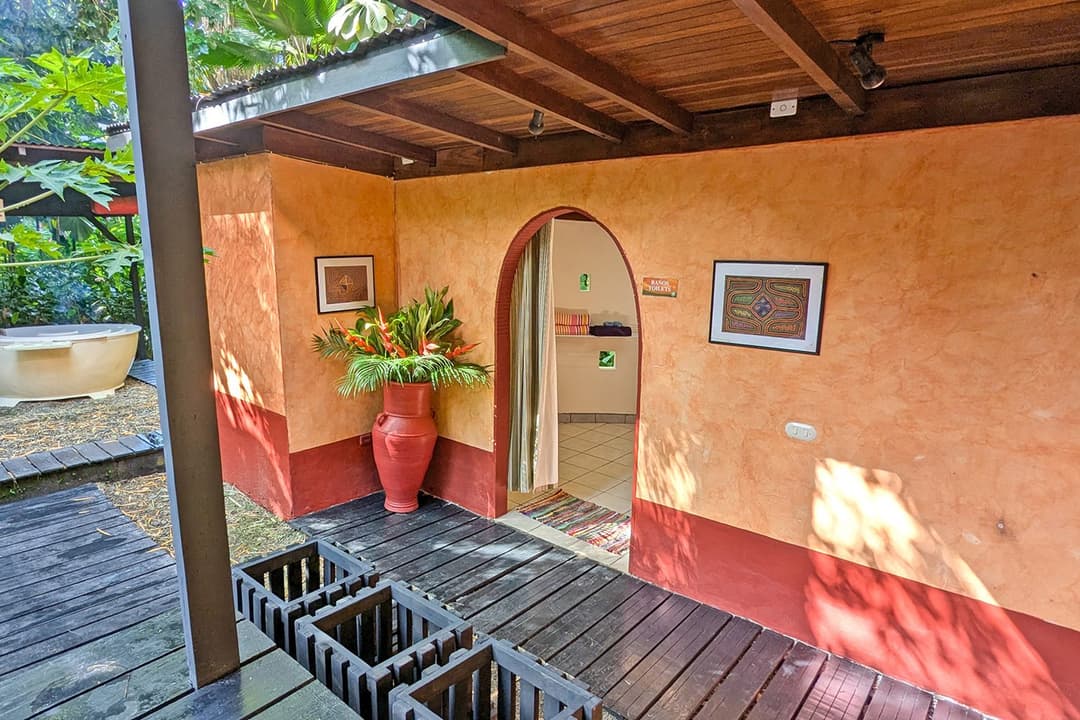 Hammock on the covered deck, garden behind